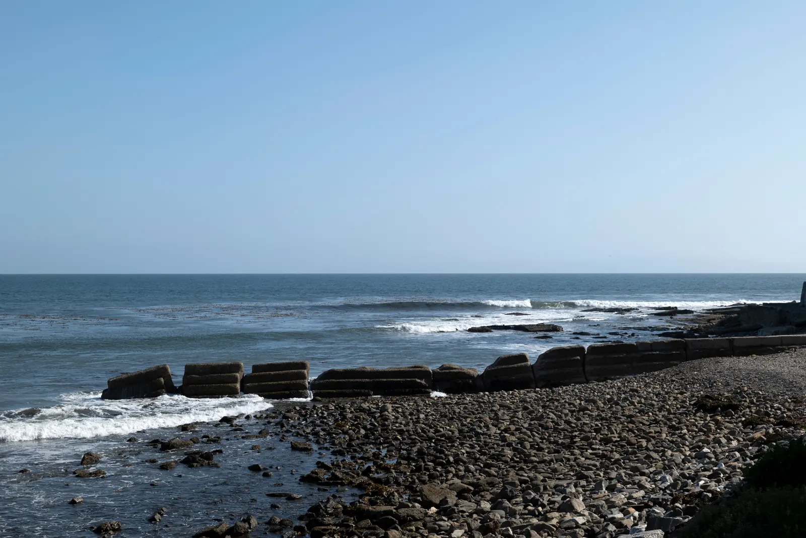 A rocky South Bay shoreline meeting the Pacific