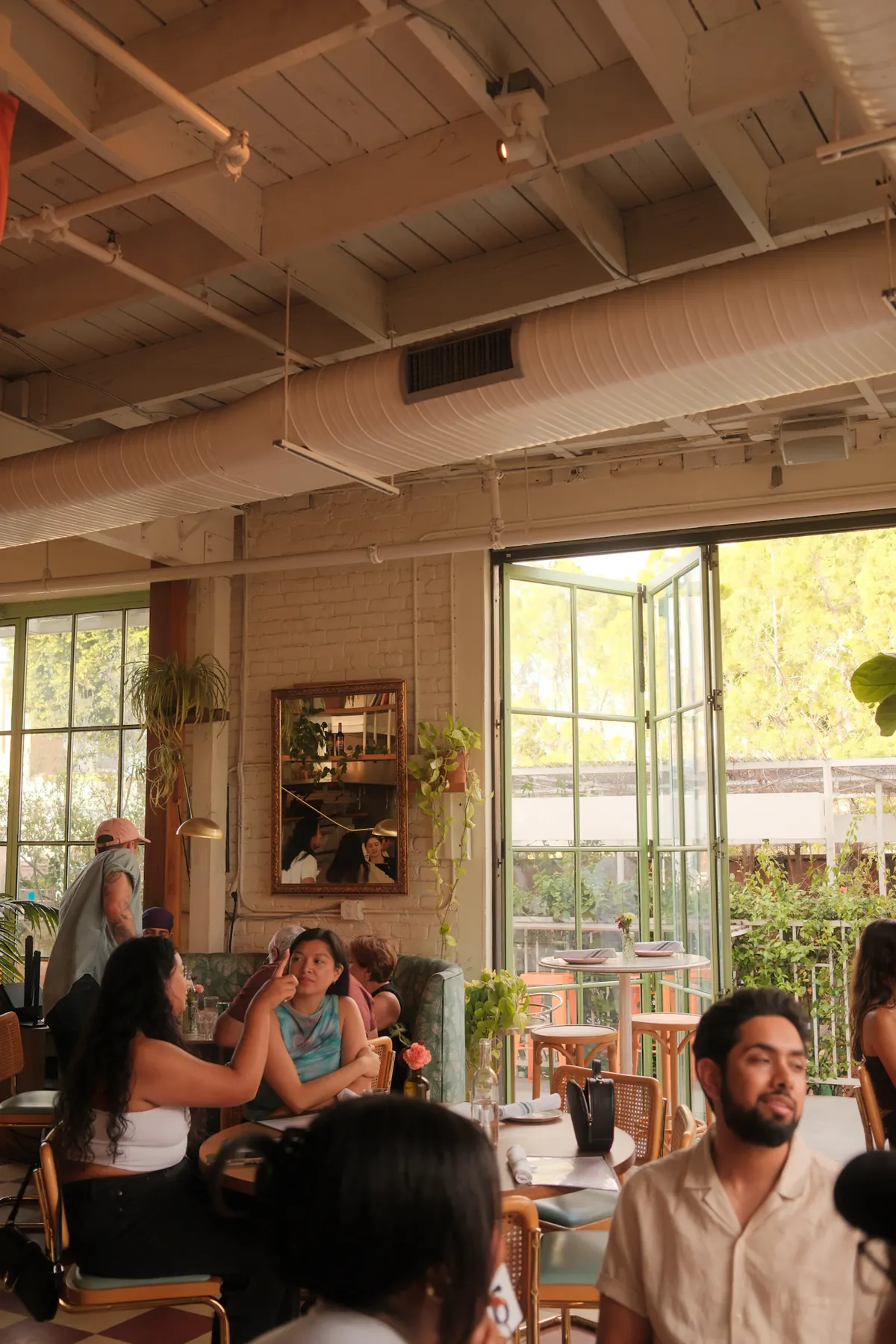 People sharing a meal inside a bright neighborhood cafe