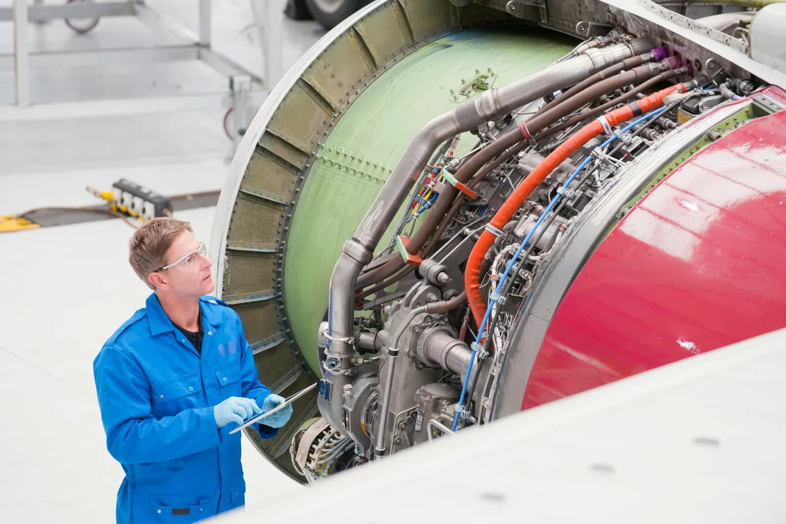 An aerospace engineer inspecting a passenger jet engine