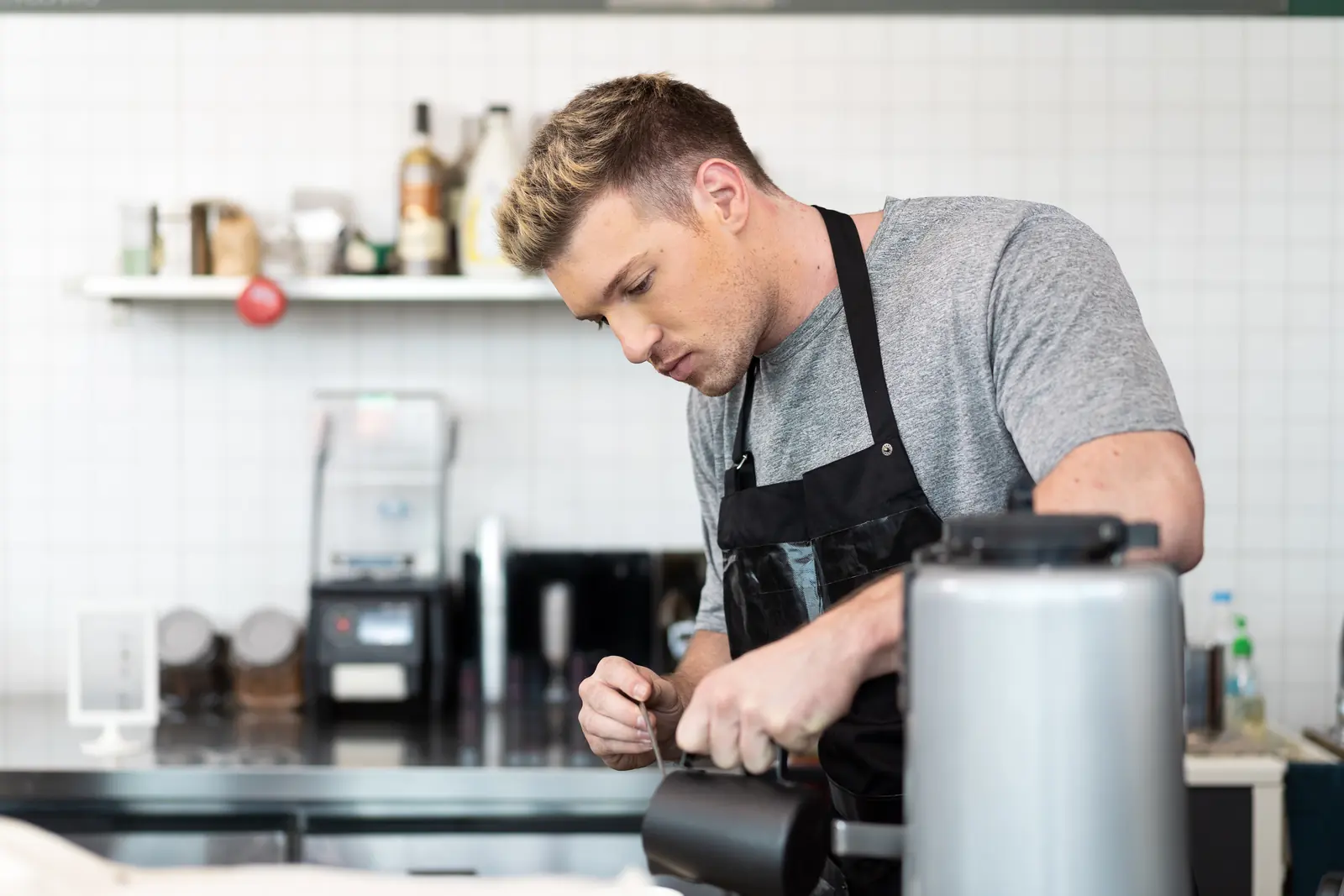 A barista preparing a fresh cup of coffee
