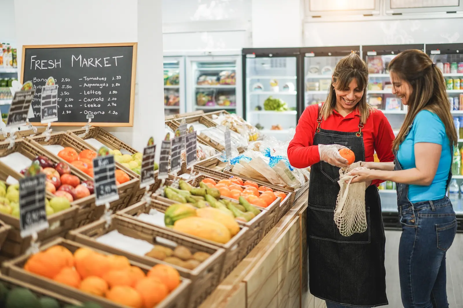 A shopper choosing fresh fruit at a farmers market