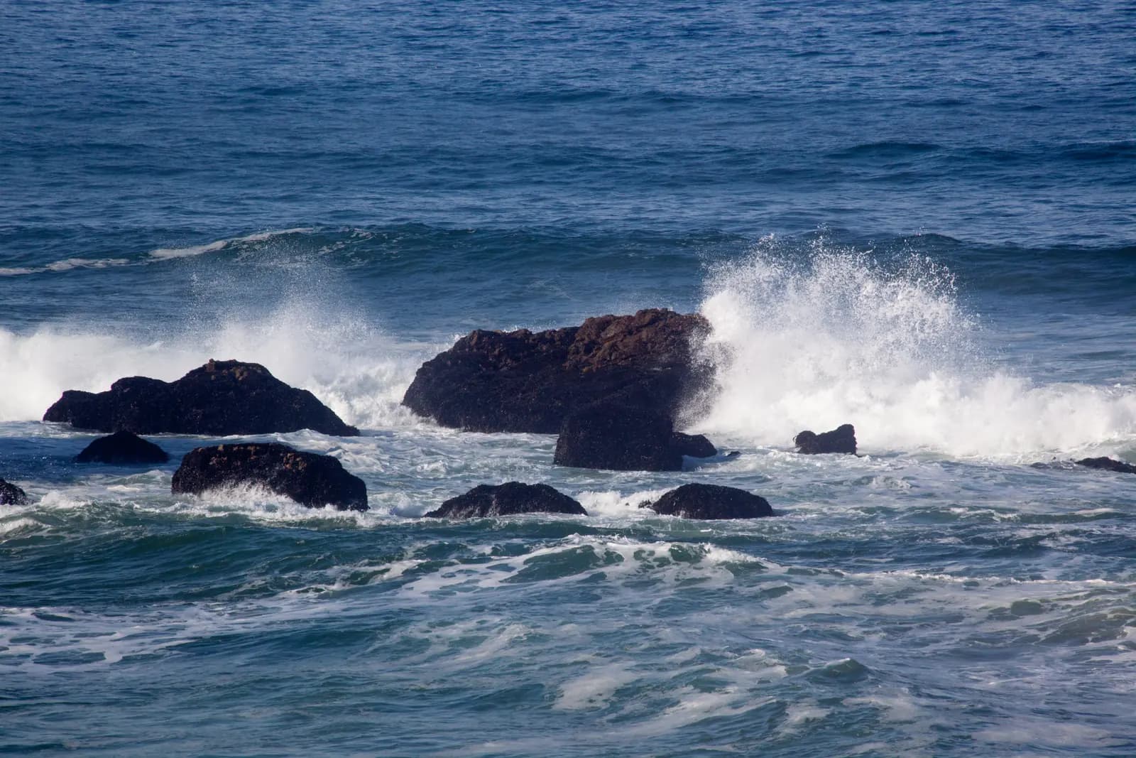 Pacific waves breaking across a rocky California shoreline