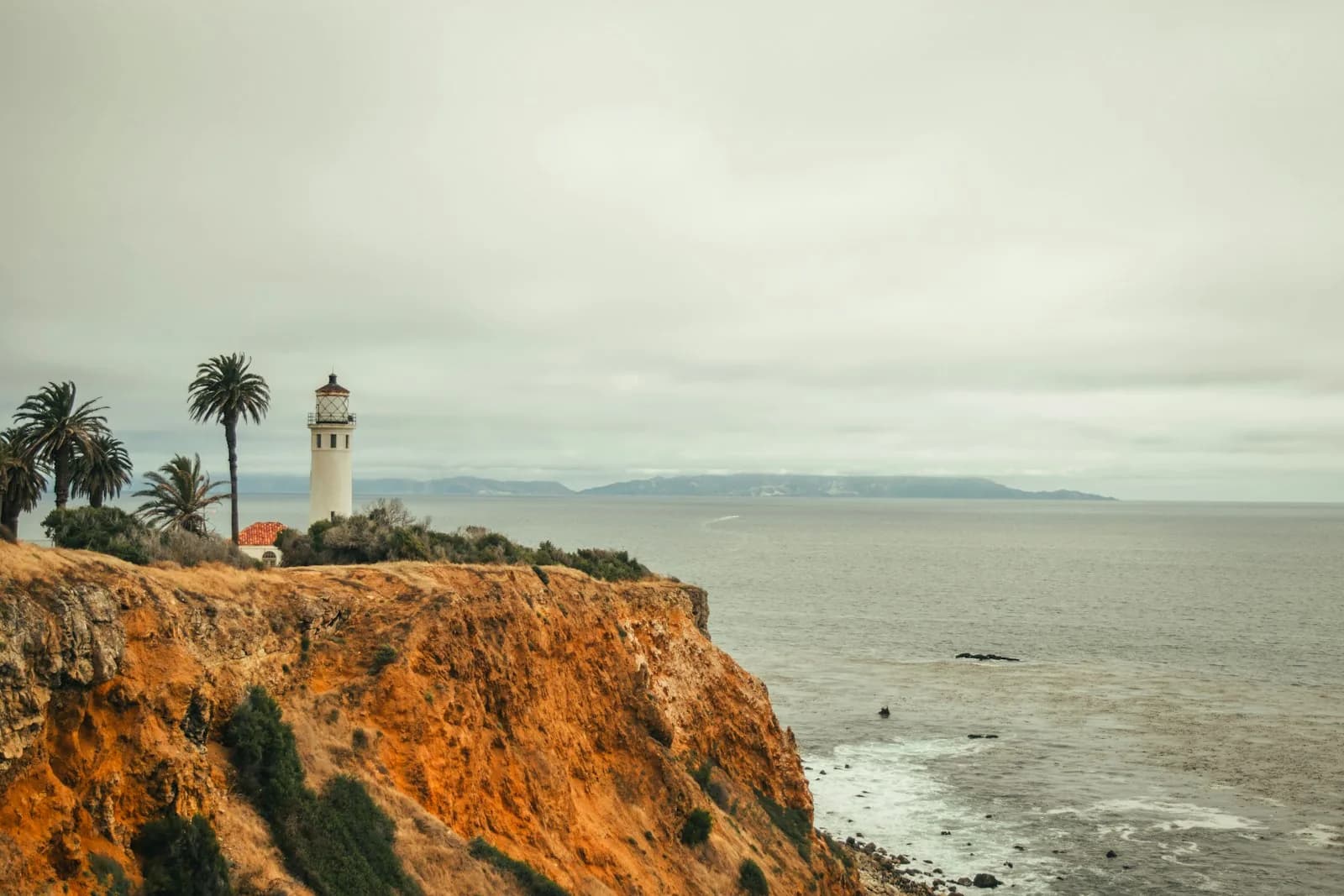 Point Vicente Lighthouse seen across ochre coastal bluffs