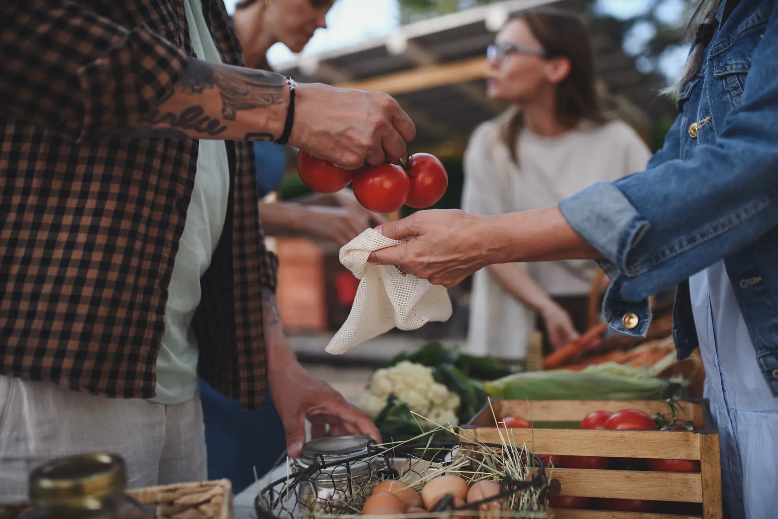 A shopper browsing fresh produce at a farmers market
