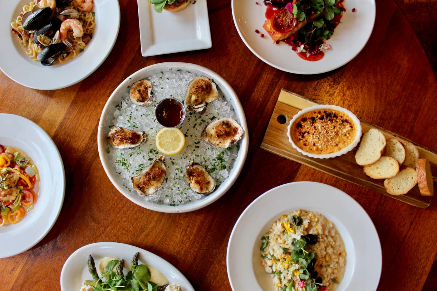 A restaurant table arranged with varied seafood dishes