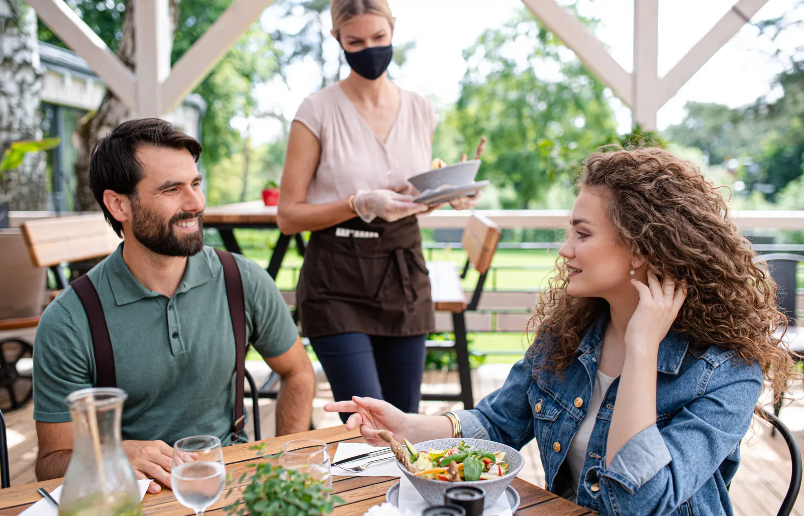 A couple dining together on an outdoor restaurant terrace