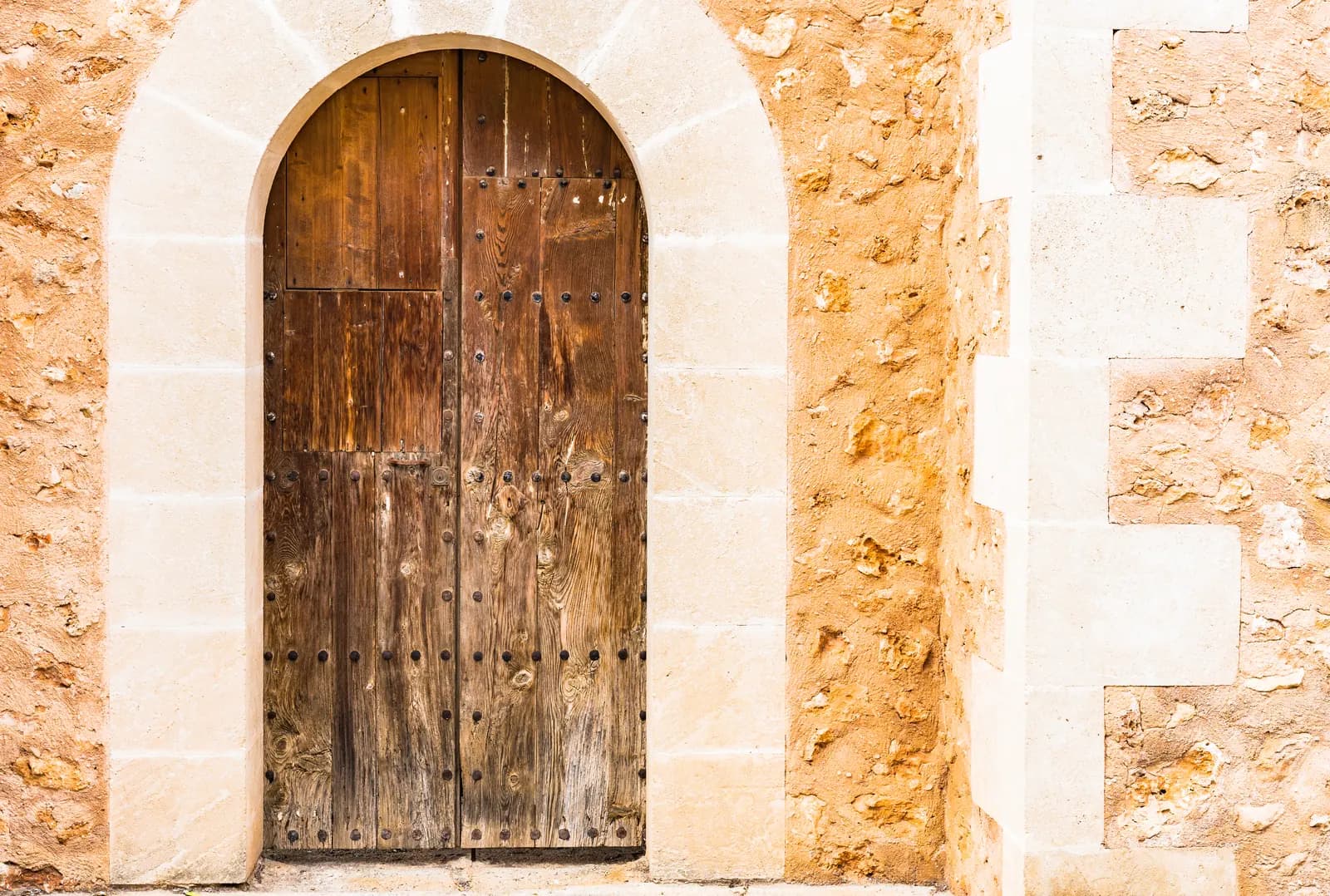 A stone-trimmed home with a prominent arched entry