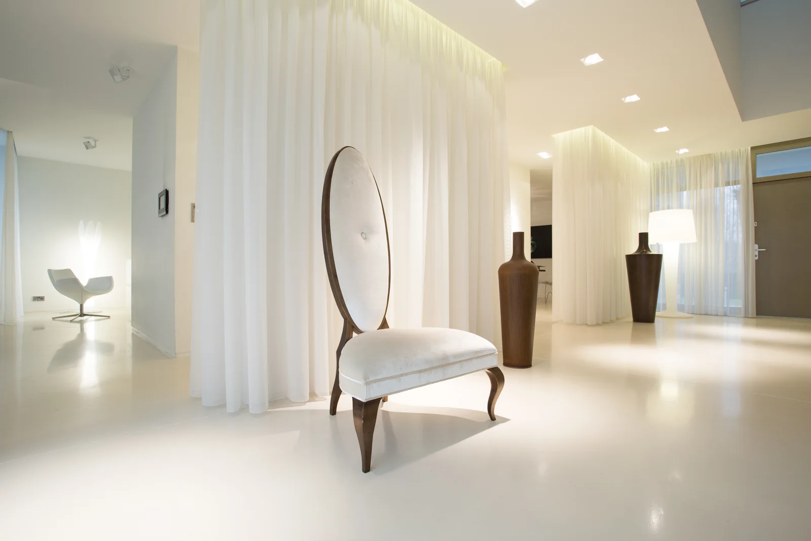 A bright white luxury-home entry with modern furnishings