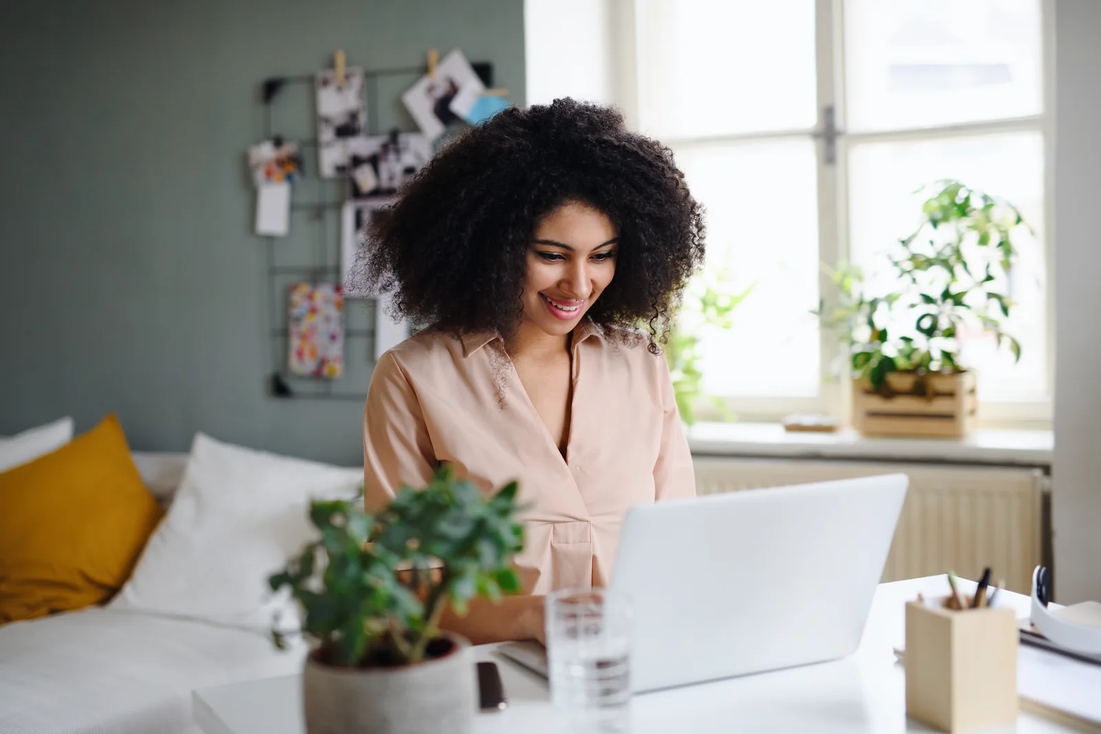 A buyer searching for homes online from a bright living space